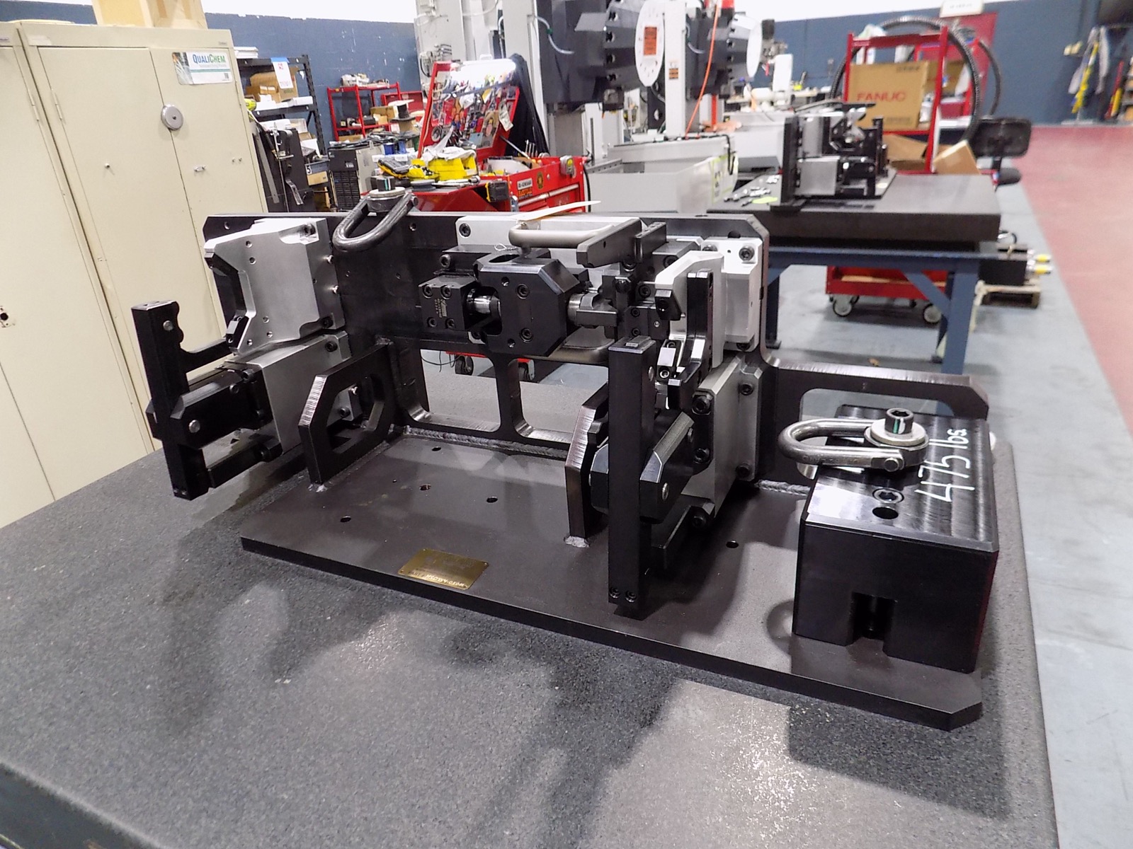 Custom fixture assembly used to hold axle tubes during keyway and thread rolling operations.