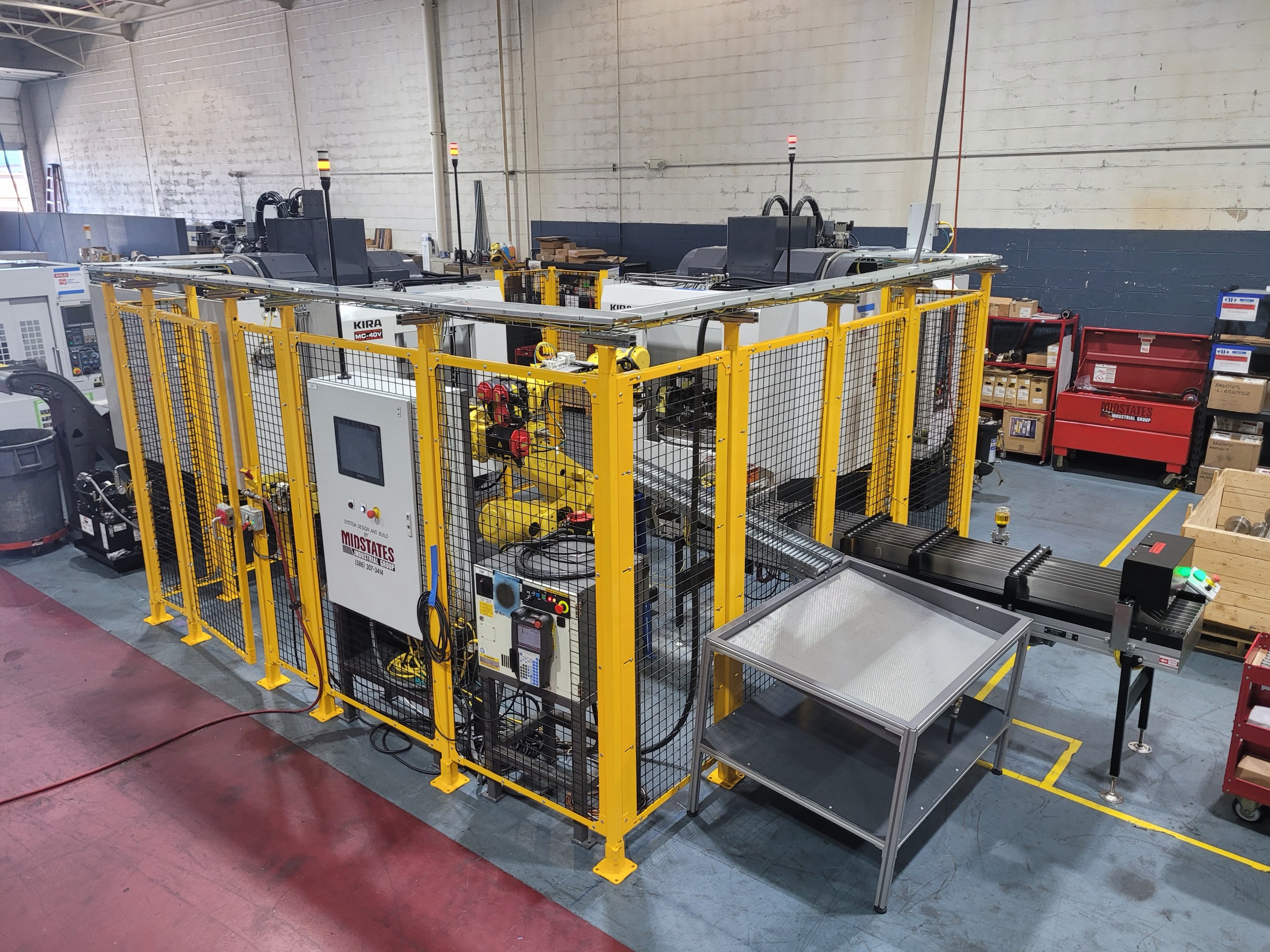 Completed cell overview showing machine, fencing, and conveyance.